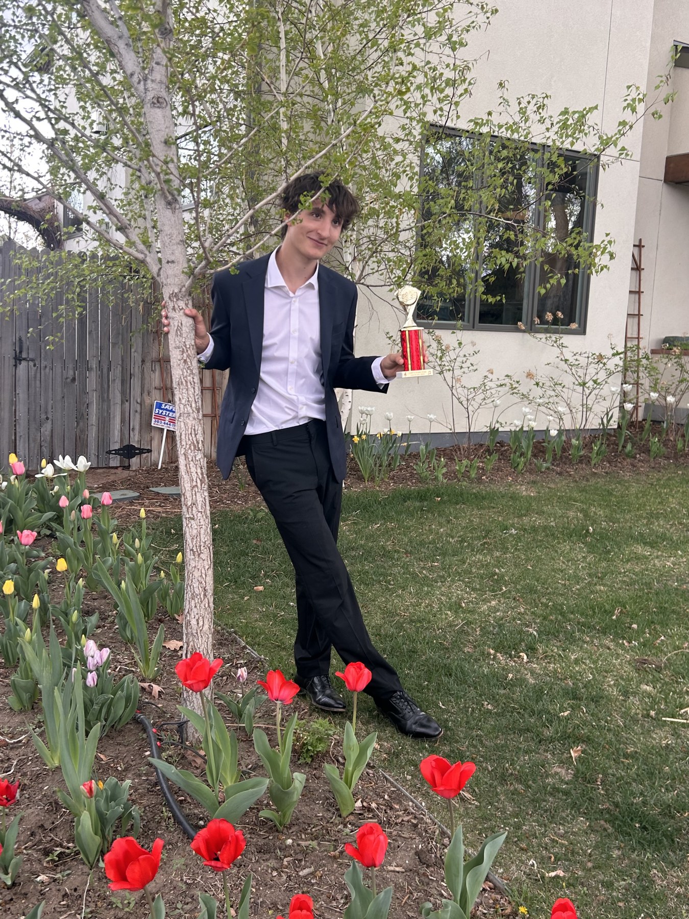 Nico van Doorninck today, holding a piano competition trophy outdoors