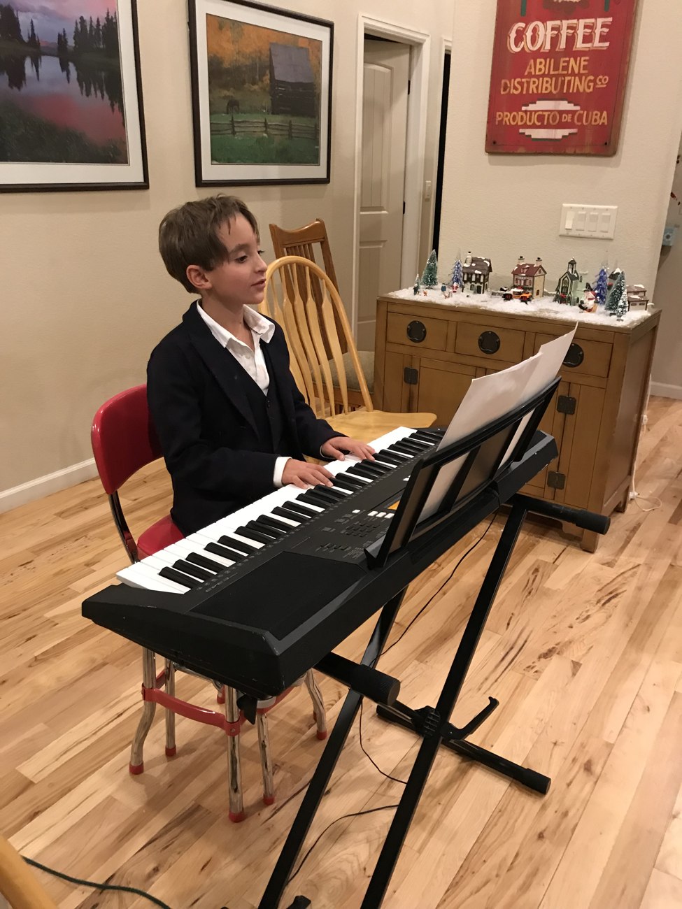 A younger Nico playing a digital piano
